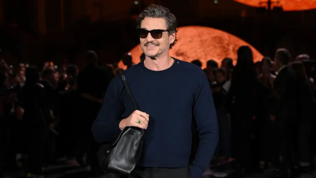 Pedro Pascal en desfile de Chanel con look sofisticado y bolso negro, durante evento en París. Fotografía de GQ España